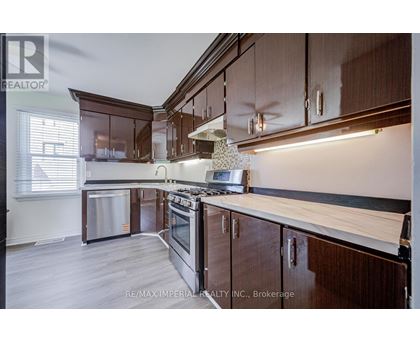 A kitchen with wooden cabinets and a stove top oven.