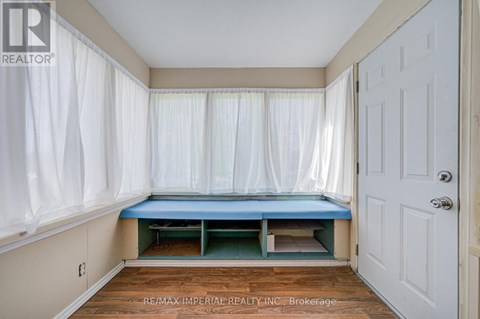 A bedroom with a bed in the corner and a white door.