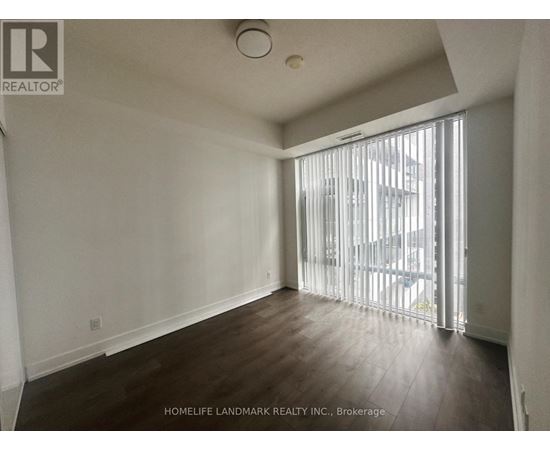 A room with a sliding glass door leading to a balcony.