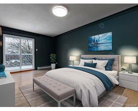 A bedroom with a large bed and a painting on the wall.