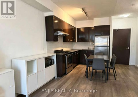 A modern kitchen with a dining table and chairs.