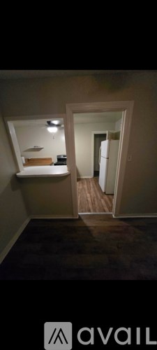 A dark room with a bed and a door.