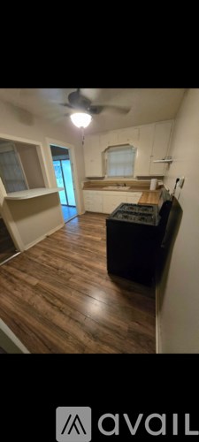 A room with wooden floors and a ceiling fan.