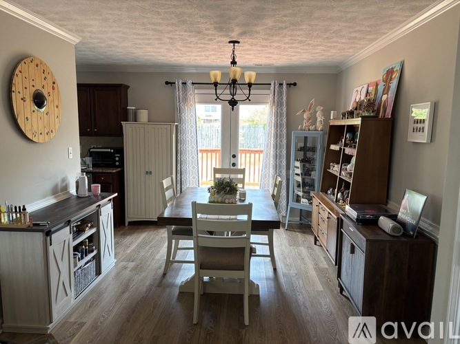 A kitchen with a dining table and chairs in the middle of the room.