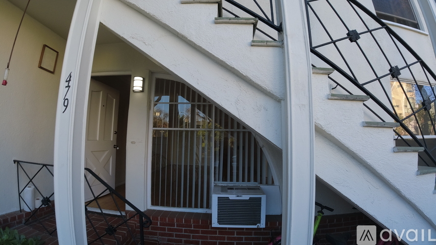 A white building with a balcony and a window.