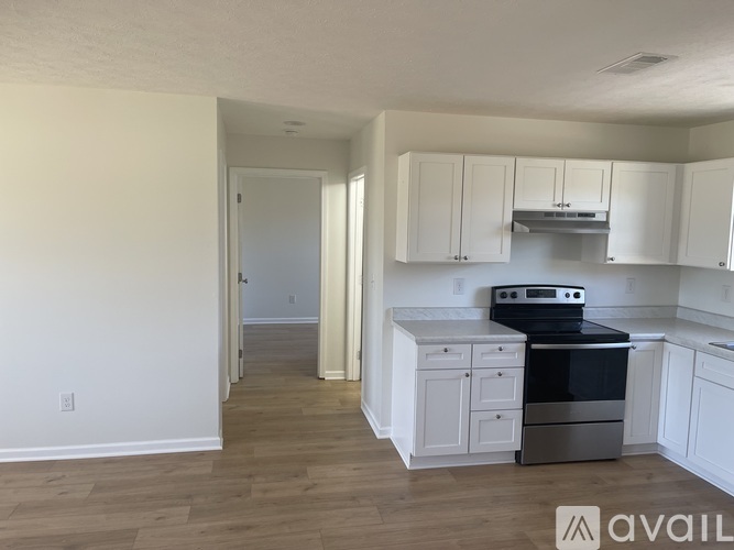 A kitchen with white cabinets and a stainless steel oven.