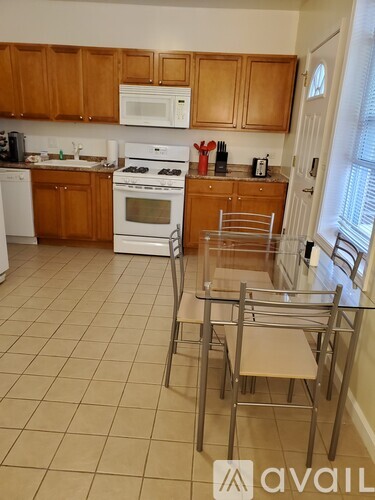 A kitchen with wooden cabinets and white appliances.