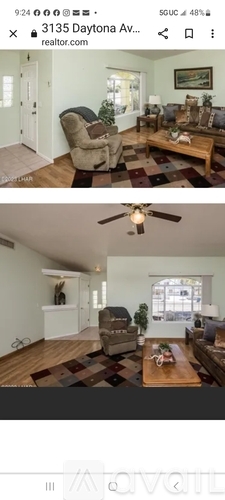 A living room with a brown couch and a wooden coffee table.