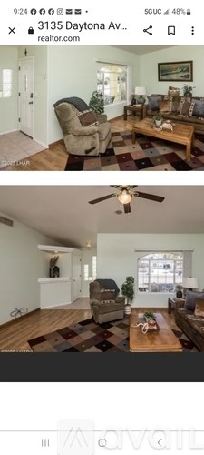 A living room with a brown couch and a wooden coffee table.
