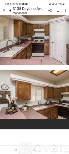 A kitchen with wooden cabinets and a white door.