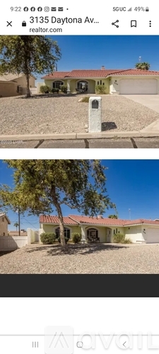 A house with a red roof and a tree in front of it.