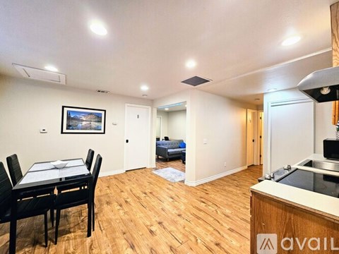 A living room with a dining table and chairs.