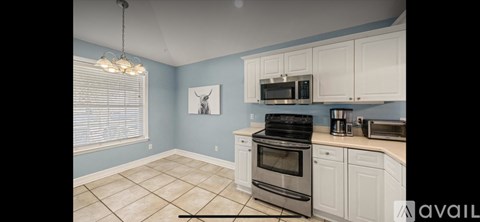 A kitchen with a stove top oven and a microwave.