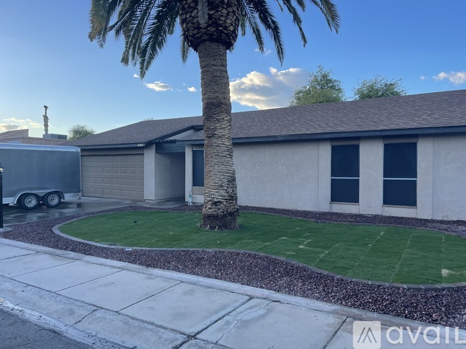 A house with a palm tree in front of it.