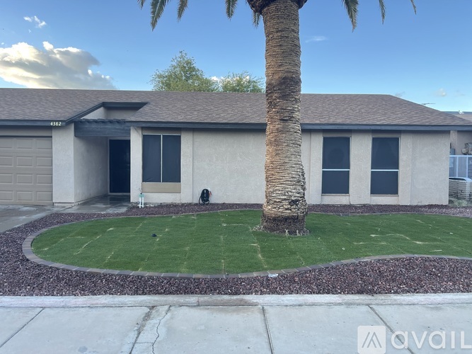 A house with a palm tree in front.