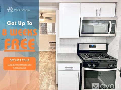 A kitchen with a stove and a microwave oven.