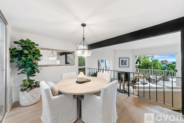 A dining room with a round table and chairs.