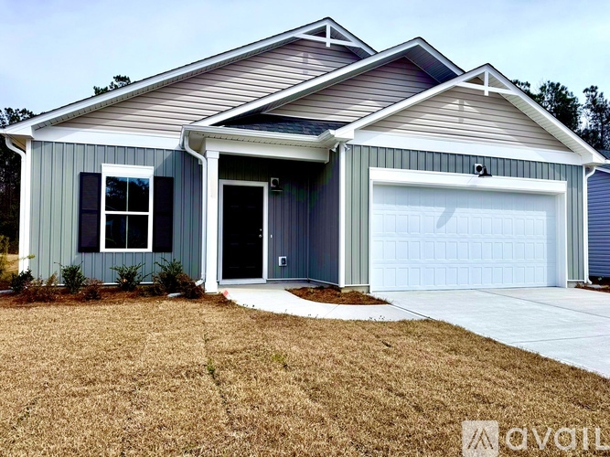 A two-story house with a garage door and a window.