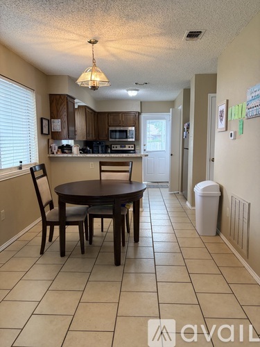 A kitchen with a table and chairs in the middle of the room.