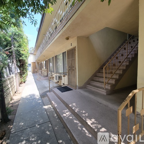 A sunny day at a residential area with a staircase leading to a building.