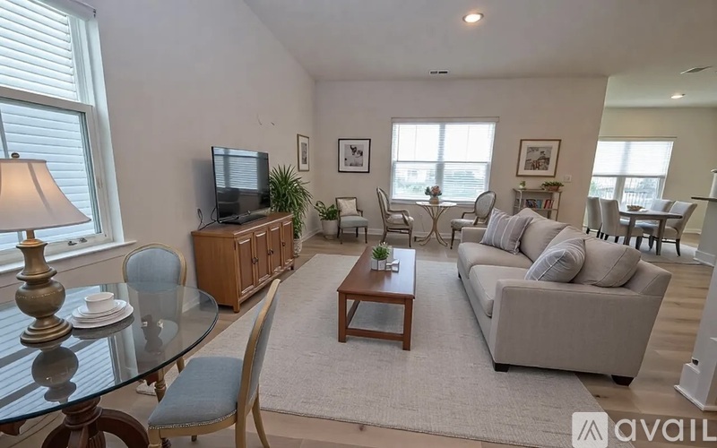 A living room with a glass table and a television.