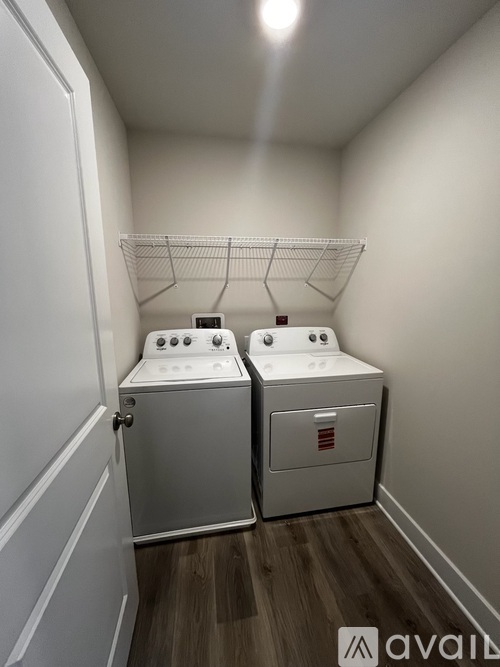 Two white ovens in a small kitchen.