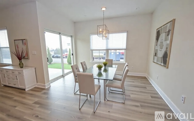 A dining room with a glass table and chairs.