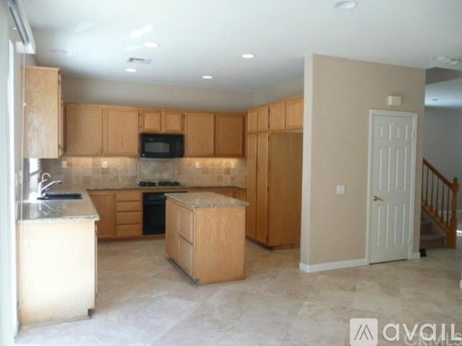 A kitchen with wooden cabinets and a countertop.