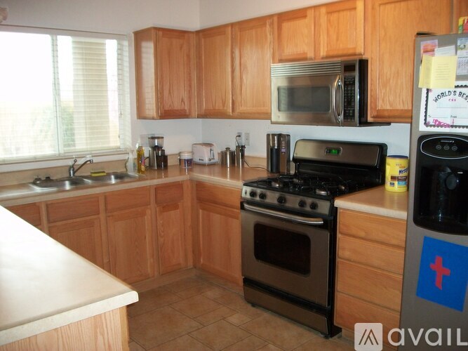 A kitchen with wooden cabinets and a black stove top oven.