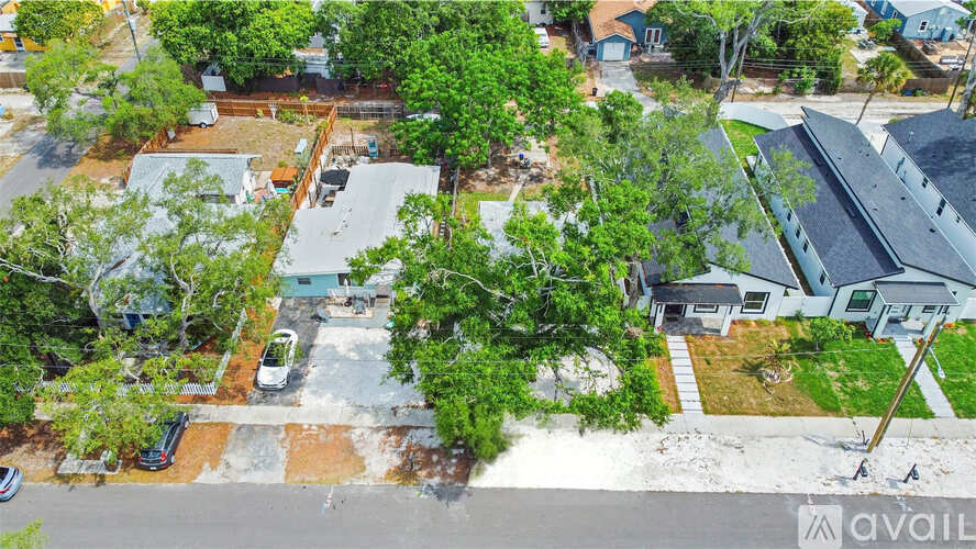 A bird's eye view of a residential area with houses and trees.