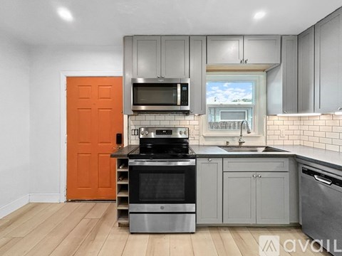 A kitchen with a stove top oven and microwave above it.