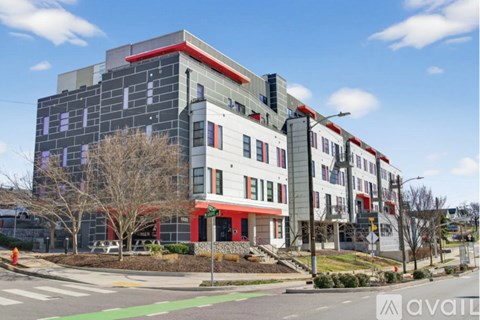 A modern multi-story building with a red and white exterior.