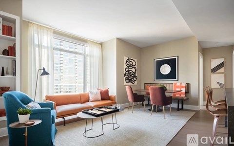 A living room with a blue chair and a brown chair.
