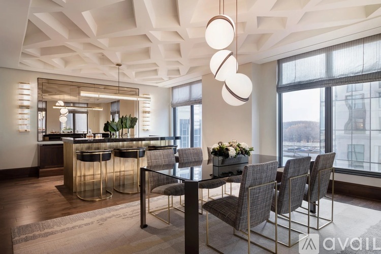A modern dining room with a large table and chairs.