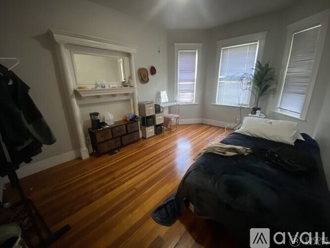 A bedroom with a bed, dresser, and mirror.
