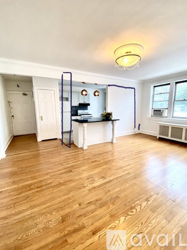 A room with wooden floors and a white door.