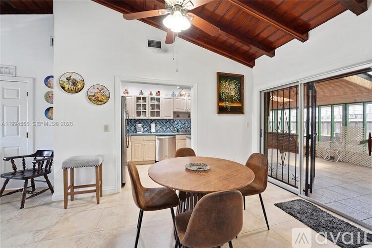 A dining room with a round table and chairs.