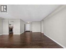 A spacious room with wooden floors and white walls.