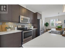 A kitchen with a white counter top and dark brown cabinets.