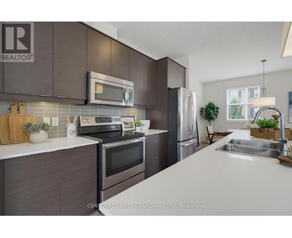 A kitchen with a white counter top and dark brown cabinets.