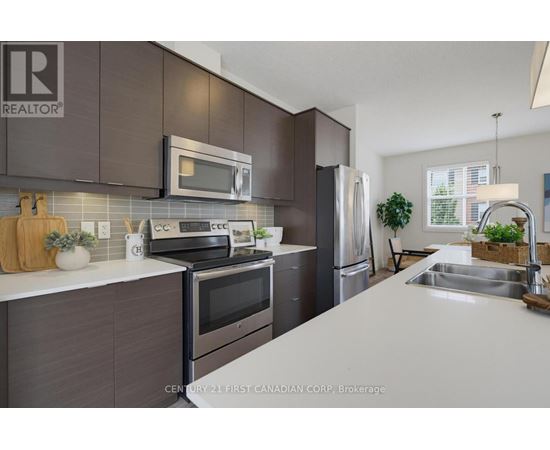 A kitchen with a white counter top and dark brown cabinets.