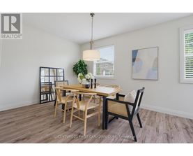 A dining room with a wooden table and chairs.