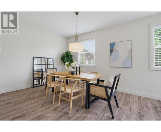 A dining room with a wooden table and chairs.