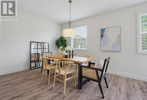 A dining room with a wooden table and chairs.