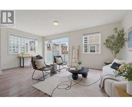A living room with a couch, chairs, and a table with a plant on it.