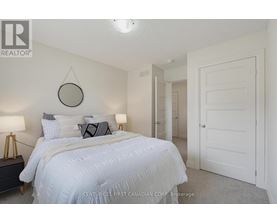 A bedroom with a large bed and a mirror on the wall.