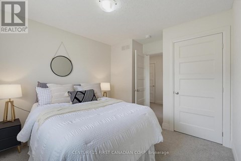 A bedroom with a large bed and a mirror on the wall.