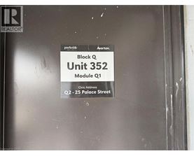 A sign on a door that says Block Q Unit 352.