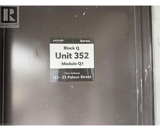 A sign on a door that says Block Q Unit 352.