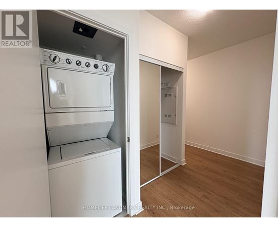 A white oven and stove top are in a kitchen area.